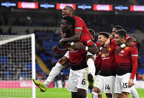 Pogba celebrating Jesse Lingard's goal with his team-mates in front of the traveling supporters